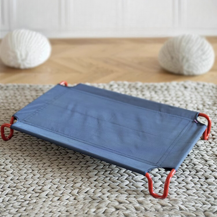 elevated dog bed with red bed frame and blue bed cloth